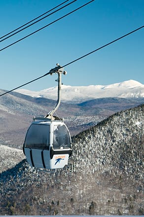 picture of Loon's gondola skyride, with NH White Mountains in the background