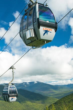 picture of Loon's gondola skyride, with NH White Mountains in the background