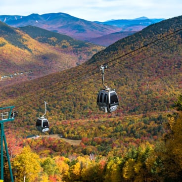 picture of Loon's gondola skyride, with NH White Mountains in background